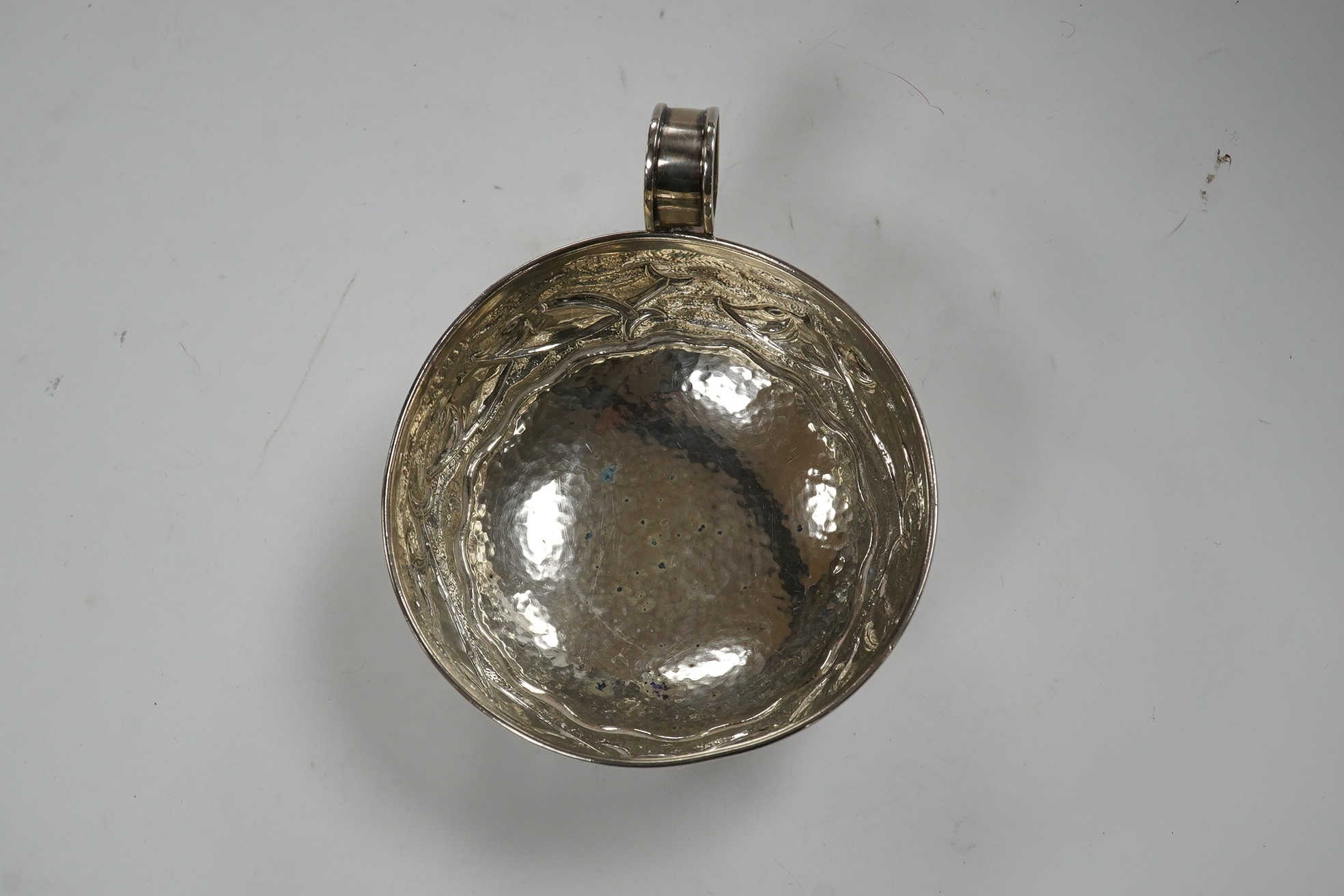A Greek Lalaounis 800 standard white metal single handled cup, embossed with fish, diameter 11.5cm, 135 grams. Condition - fair
